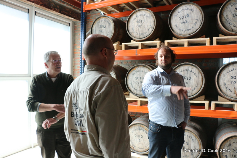 Davy Daniëls (right) in one of the barrel rooms at the Belgian Owl distillery. Master distiller Etienne Bouillon is in the center. 