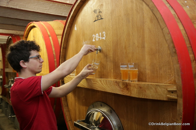 Brewer Kloris Deville pulling samples of lambic from a foeder. 