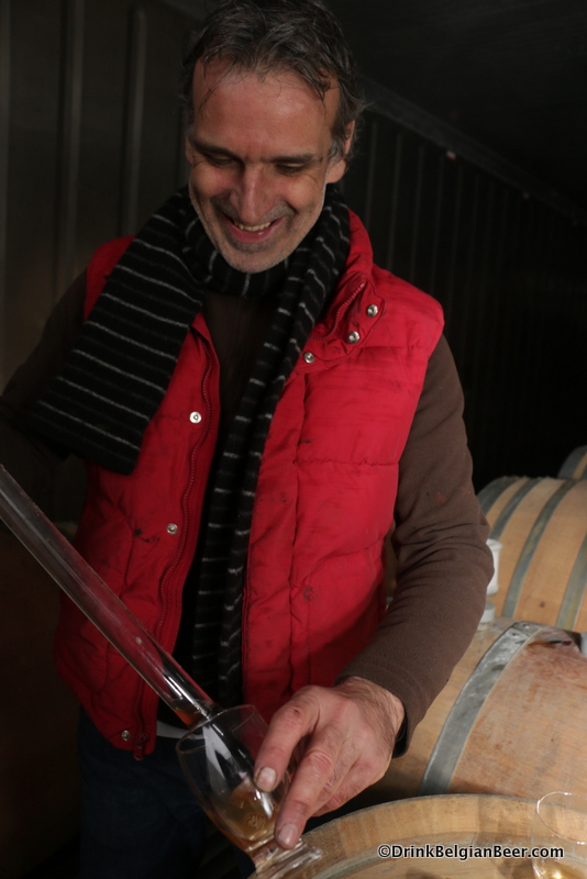 Jo Van Aert with a sample of fruited lambic pulled from a barrel. 
