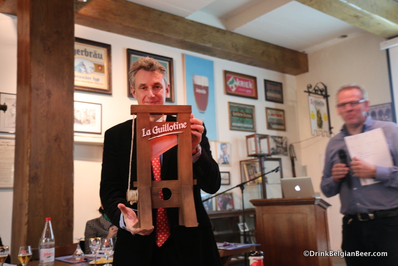 Alain de Laet, owner, Brouwerij Huyghe, with a miniature guillotine.