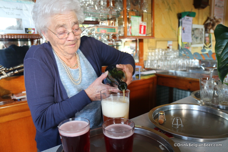 Lisa pouring a Hanssens Oude Gueuze into an old Winderickx lambic glass.