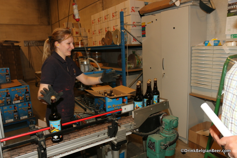 A young lady packaging bottles at St. Bernardus. 
