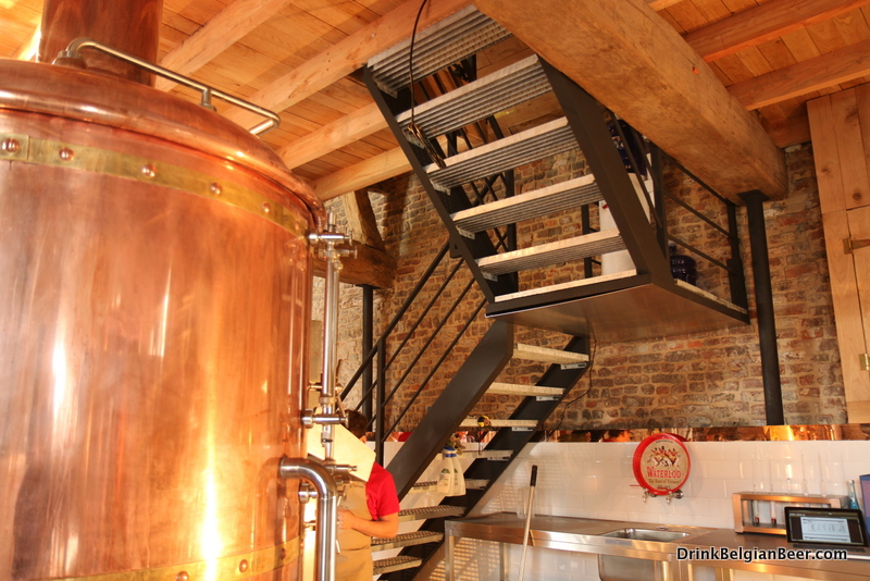 The brewery mash tun is on the left. Steps lead to a second floor, where grains and other supplies are kept.
