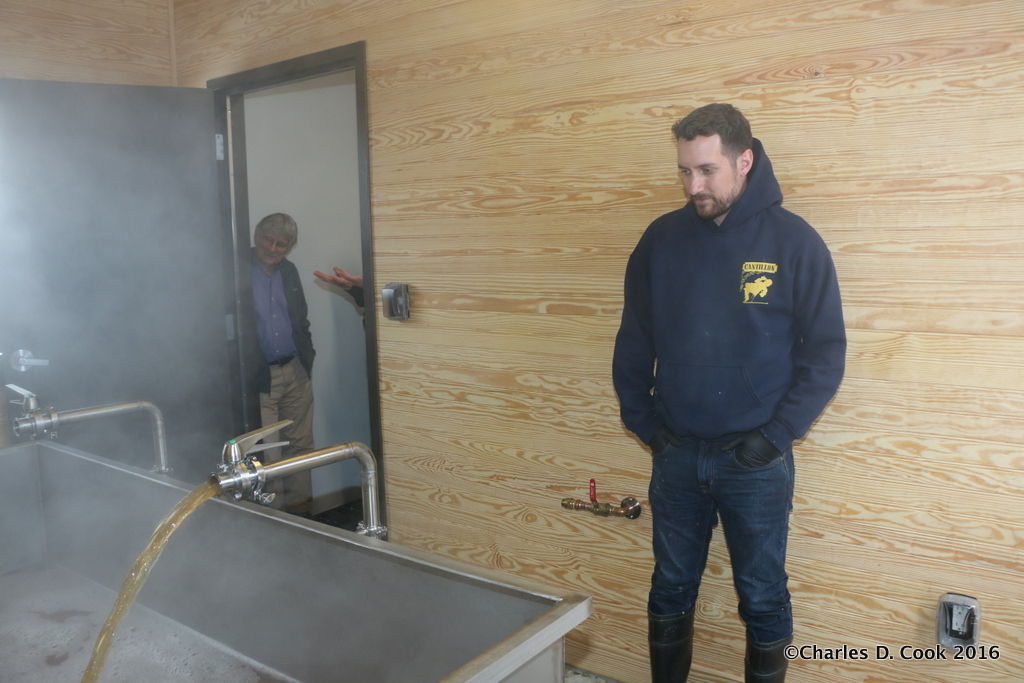 Brewer and co-founder Matt Tarpey looks on as his coolship fills with hot wort. 
