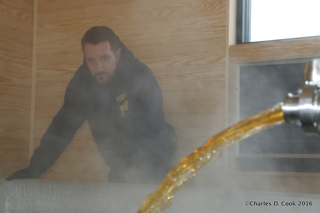 Veil brewer and co-founder Matt Tarpey looks on as his coolship fills with wort.