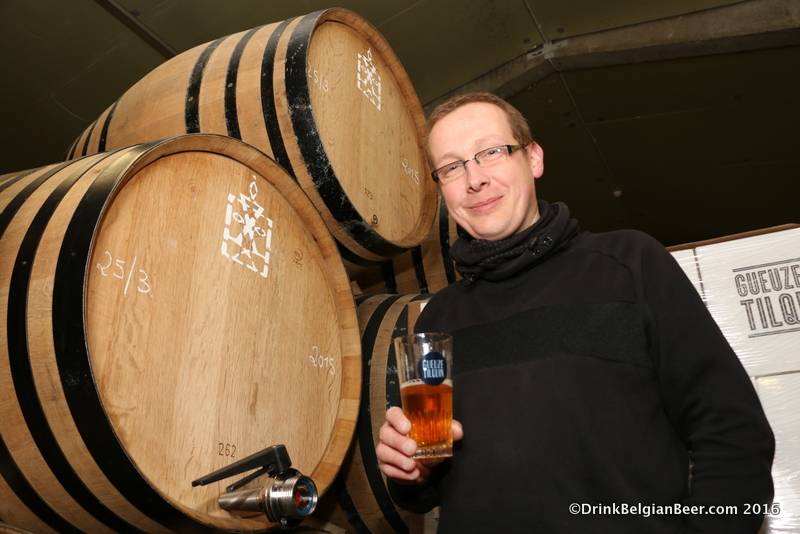Pierre Tilquin with a glass of lambic pulled directly from the barrel to his right. 