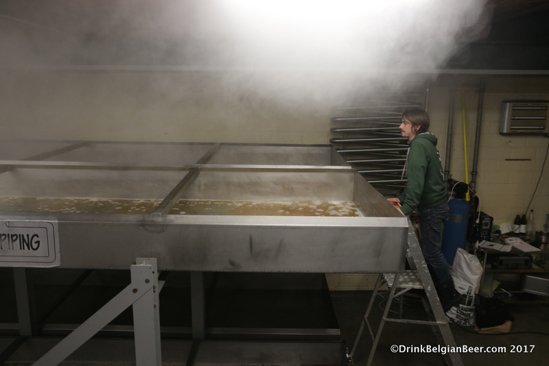 3 Fonteinen brewer Diego Sachem looks at the progress of wort filling the top deck of their coolship. 