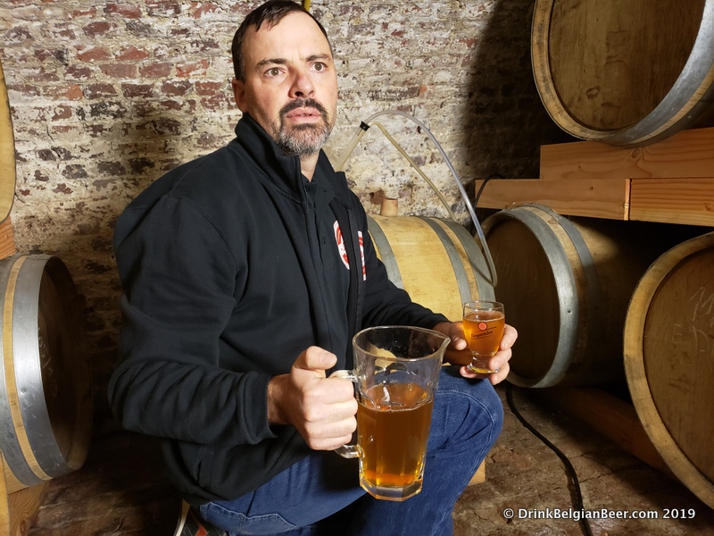 Brouwerij Sako brewer Koen Christiaens with a pitcher of lambic pulled directly from a barrel in his circa 1800 cellar. 