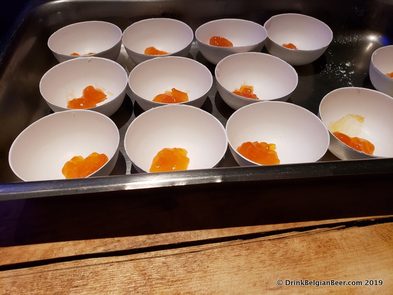 Dishes of pureed apricots ready to be paired with deep fried chocolate and served to hungry fest attendees. 