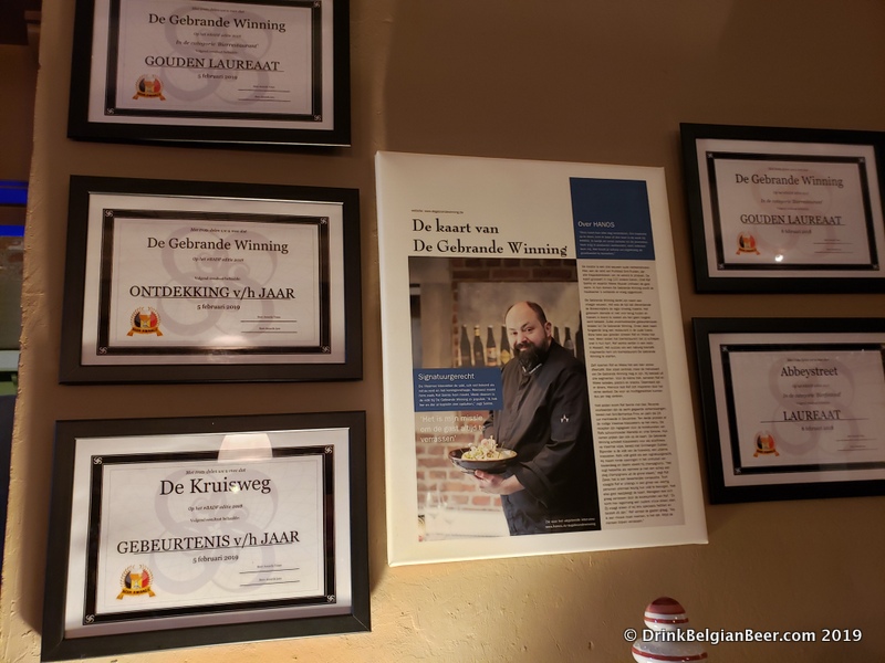 Some of the awards De Gebrande Winning has received, on a wall near the bar. 