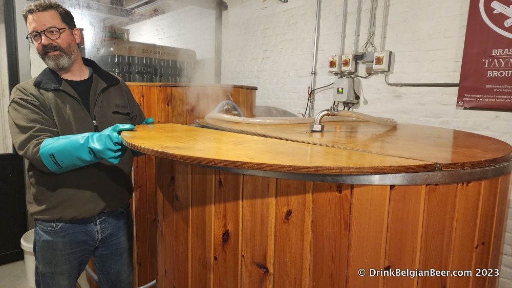 Jean-Marc Taymans, brewer and co-owner of Brasserie/Brouwerij Taymans, opening the steaming mash tun in February 2023. 